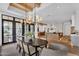 Elegant dining room with a dark wood table, stylish chandelier, and views to the outdoor patio at 20649 E Vallejo Ct, Queen Creek, AZ 85142