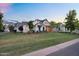 Well-manicured front lawn with mature trees, complementing the home's sophisticated exterior design at 20649 E Vallejo Ct, Queen Creek, AZ 85142