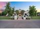 Charming front exterior with manicured lawn, flower-lined path, and inviting entrance at 20649 E Vallejo Ct, Queen Creek, AZ 85142