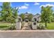 Stunning white brick home with lush landscaping and a charming brick pathway to the front door at 20649 E Vallejo Ct, Queen Creek, AZ 85142