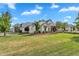 Expansive green lawn with manicured landscaping enhances this beautiful home's curb appeal at 20649 E Vallejo Ct, Queen Creek, AZ 85142