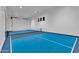 A pickleball court is found in the game room and a garage door for access at 20649 E Vallejo Ct, Queen Creek, AZ 85142