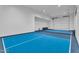Bright pickleball court in game room with garage door at 20649 E Vallejo Ct, Queen Creek, AZ 85142