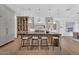Spacious kitchen with center island, barstool seating, custom cabinets, and pendant lighting at 20649 E Vallejo Ct, Queen Creek, AZ 85142