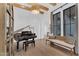 Elegant living room with hardwood floors, piano, and large windows at 20649 E Vallejo Ct, Queen Creek, AZ 85142