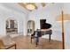 Stylish living room featuring hardwood floors, piano, and modern lighting at 20649 E Vallejo Ct, Queen Creek, AZ 85142
