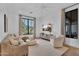 Bright living room with large windows, neutral furniture, and hardwood floors provides a comfortable retreat at 20649 E Vallejo Ct, Queen Creek, AZ 85142