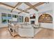 Bright living room with a fireplace, built-in shelving, and a coffered ceiling with wood beams at 20649 E Vallejo Ct, Queen Creek, AZ 85142
