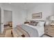 Cozy main bedroom features an upholstered bed with decorative pillows, a ceiling fan, and an ensuite sitting area at 20649 E Vallejo Ct, Queen Creek, AZ 85142
