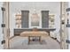 Elegant office with custom built-ins, light wood desk and modern chandelier at 20649 E Vallejo Ct, Queen Creek, AZ 85142