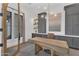 A home office with custom built-ins, stylish lighting, and bright light from the glass door at 20649 E Vallejo Ct, Queen Creek, AZ 85142