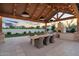 Enjoy outdoor dining under a covered patio with a built-in grill and scenic backyard views at 20649 E Vallejo Ct, Queen Creek, AZ 85142