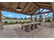 Elegant outdoor kitchen with built-in grill and dining area, perfect for entertaining and enjoying the outdoors at 20649 E Vallejo Ct, Queen Creek, AZ 85142