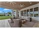 Covered patio area includes an oversized comfortable couch and ceiling fans providing an ideal outdoor living space at 20649 E Vallejo Ct, Queen Creek, AZ 85142