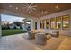 Covered patio with comfortable seating and outdoor ceiling fans at 20649 E Vallejo Ct, Queen Creek, AZ 85142