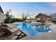 A serene pool with lounge chairs and a covered outdoor dining area is perfect for entertaining at 20649 E Vallejo Ct, Queen Creek, AZ 85142