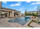 Beautiful pool area with lounge chairs, fire pit, and a partial view of the house at 20649 E Vallejo Ct, Queen Creek, AZ 85142
