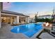 A private pool with a built-in fire feature offers a luxurious outdoor experience at dusk at 20649 E Vallejo Ct, Queen Creek, AZ 85142