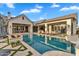 Inviting backyard oasis with a large pool, lounge chairs, firepit, and manicured landscaping for ultimate relaxation at 20649 E Vallejo Ct, Queen Creek, AZ 85142