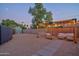 Backyard featuring pergola with swing seating, privacy fence, gravel landscape, and a storage shed at 2227 N 16Th Ave, Phoenix, AZ 85007
