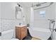 Modern bathroom with standalone tub, stylish vanity, and chic black and white tile at 2227 N 16Th Ave, Phoenix, AZ 85007