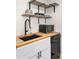 Kitchen with modern sink, floating shelves, and butcher block countertops offering a stylish space at 2227 N 16Th Ave, Phoenix, AZ 85007
