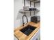 Close-up of a modern kitchen sink and floating shelves in a bright, well-designed space at 2227 N 16Th Ave, Phoenix, AZ 85007