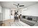 Cozy living room featuring modern gray sofa, black ceiling fan, and seamless open layout to the kitchen at 2227 N 16Th Ave, Phoenix, AZ 85007