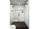 Modern tiled shower boasts glass doors and a black shower system, offering a sleek and luxurious showering experience at 2227 N 16Th Ave, Phoenix, AZ 85007