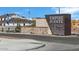 The entrance to the Empire Pointe community showcases a beautiful sign with stone accents and landscaping at 22699 E Happy Rd, Queen Creek, AZ 85142