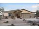 Charming single-story home featuring a three-car garage and low-maintenance desert landscaping at 22699 E Happy Rd, Queen Creek, AZ 85142