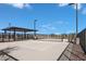 A community pickleball court with benches, lighting and a covered seating area at 22699 E Happy Rd, Queen Creek, AZ 85142
