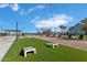Outdoor common area with artificial turf, cornhole setups, lounge seating, and decorative string lights at 22705 E Happy Rd, Queen Creek, AZ 85142
