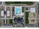 Aerial view of a community pool and amenity area with covered seating, playground, lounging chairs, and sports courts at 22705 E Happy Rd, Queen Creek, AZ 85142