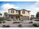Two story home boasts a neutral color palette, two-car garage, and desert landscaping for low maintenance at 23039 E Watford Dr, Queen Creek, AZ 85142