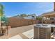 This backyard shows a gravel area with an air conditioner and a wall offering privacy at 2341 S Gordon --, Mesa, AZ 85209