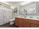 This bathroom features a double sink vanity, decorative mirror, and a shower with a curtain at 2341 S Gordon --, Mesa, AZ 85209