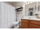 This bathroom features a single sink vanity, storage shelf, and shower with a curtain at 2341 S Gordon --, Mesa, AZ 85209