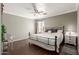 This bedroom features a ceiling fan, wood floors, neutral paint, and a queen-sized bed at 2341 S Gordon --, Mesa, AZ 85209