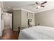 A bedroom featuring a ceiling fan, wood floors, neutral paint, and a queen-sized bed at 2341 S Gordon --, Mesa, AZ 85209