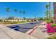 The community entrance is on a tree-lined street featuring tropical landscaping and blooming bougainvillea at 2341 S Gordon --, Mesa, AZ 85209