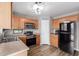 Open kitchen featuring wood cabinets, stainless steel appliances, pantry, and wood-look flooring at 2341 S Gordon --, Mesa, AZ 85209