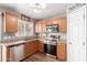 Well-lit kitchen features wood cabinets, stainless steel appliances, and a stainless steel dishwasher at 2341 S Gordon --, Mesa, AZ 85209
