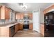 Bright kitchen with stainless steel appliances, wood cabinets, pantry, and light wood flooring at 2341 S Gordon --, Mesa, AZ 85209