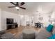 Open-concept living area featuring hardwood floors, gray sofas and television at 2341 S Gordon --, Mesa, AZ 85209