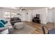 Comfortable living room boasts wood floors, a gray sofa, and natural light at 2341 S Gordon --, Mesa, AZ 85209