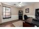 This home office features a ceiling fan, desk, wood floors, and a shelving unit at 2341 S Gordon --, Mesa, AZ 85209
