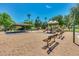 Community playground featuring shaded picnic area, play structure, and benches surrounded by mature trees at 2341 S Gordon --, Mesa, AZ 85209