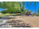 Community playground featuring swings, slides, and climbing structures on a sunny day at 2341 S Gordon --, Mesa, AZ 85209
