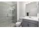 Modern bathroom showcases a glass-enclosed shower, gray vanity and updated fixtures at 2425 W Bronco Butte Trl # 2011, Phoenix, AZ 85085